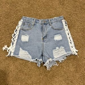 Distressed high waisted jean shorts with cut out tie sides